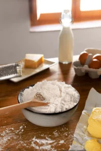 Thin crepes dusted with powdered sugar, stacked and topped with butter and lemon.