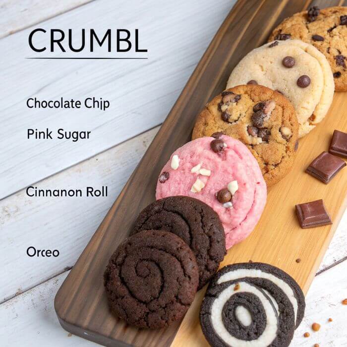 An assortment of Crumbl-style cookies on a serving board